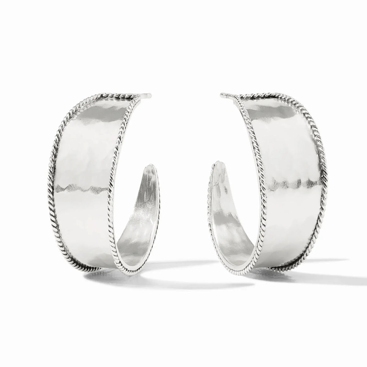 Silver Savoy hoop earring with hammered texture, twisted wire detail, curving from wide to narrow silhouette.