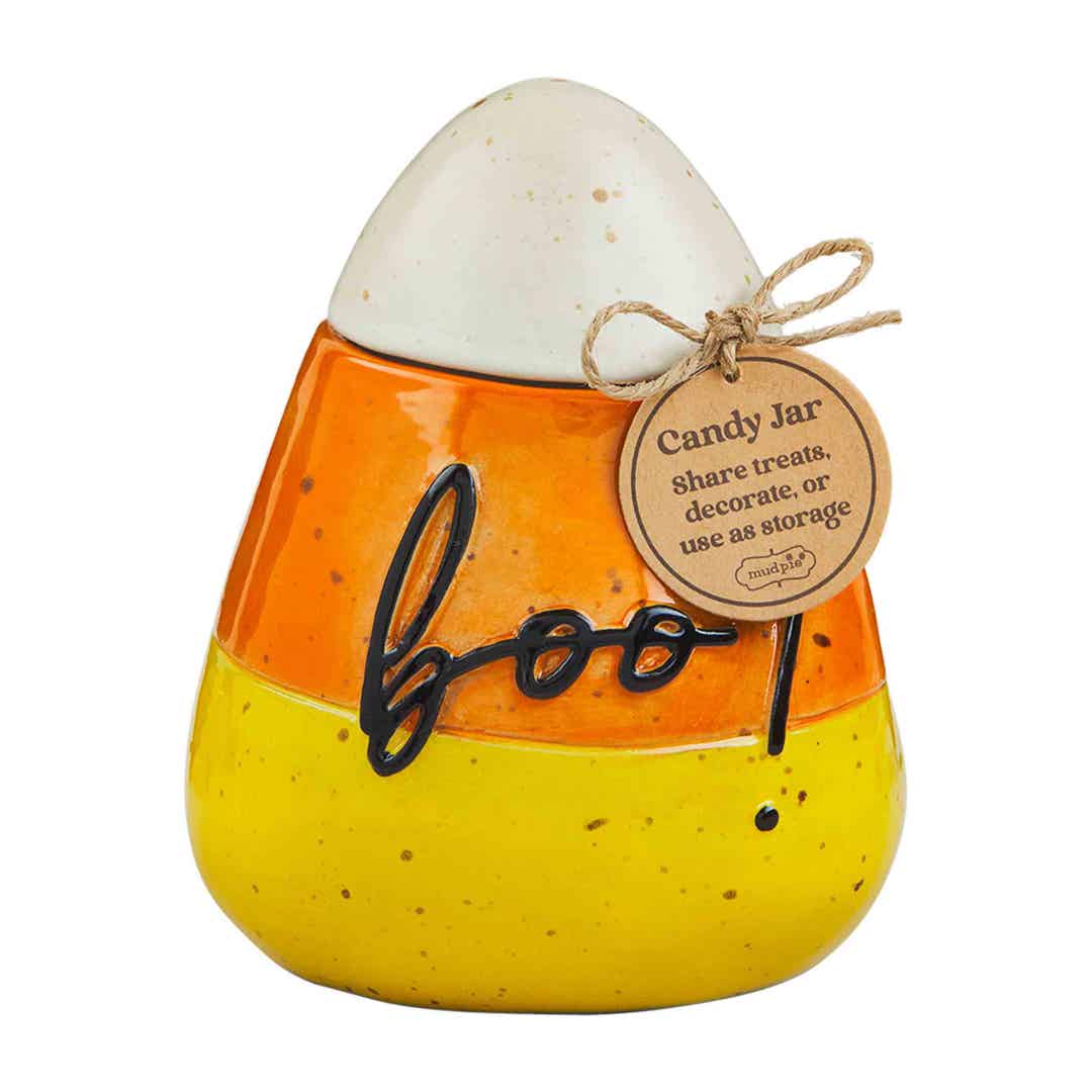 Black stoneware Halloween candy canister with white jack-o'-lantern face and orange accents.