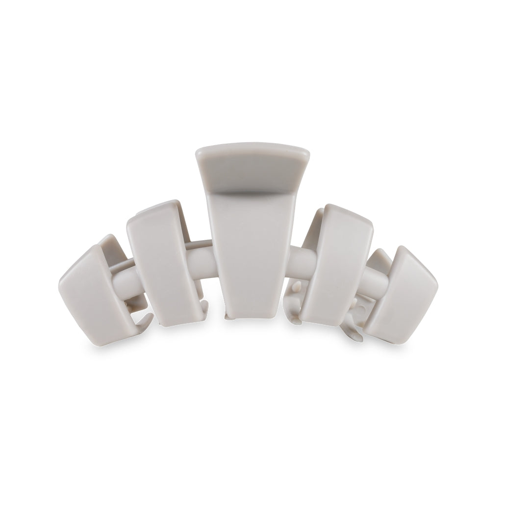 Medium-sized classic hair clip in a neutral tone with a smooth finish.
