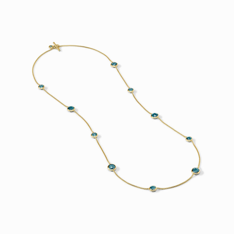 Rainbow Station Necklace in 24K gold plate with blue glass stones and a toggle closure.