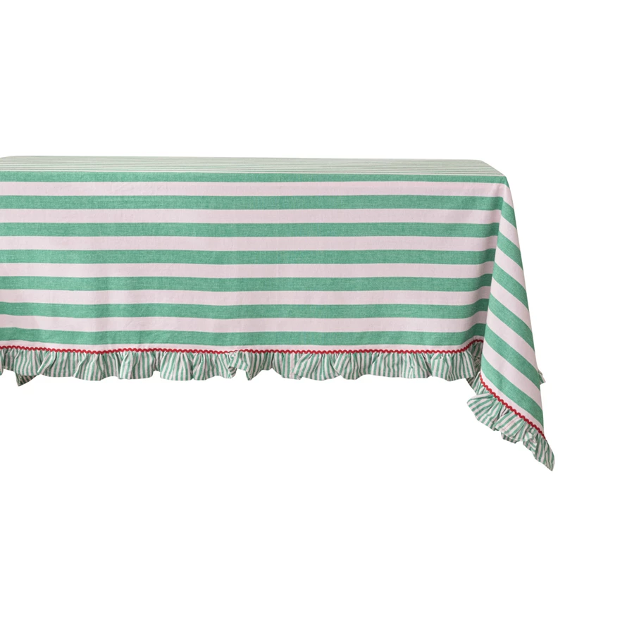 Green woven cotton striped tablecloth with pink ruffle trim.