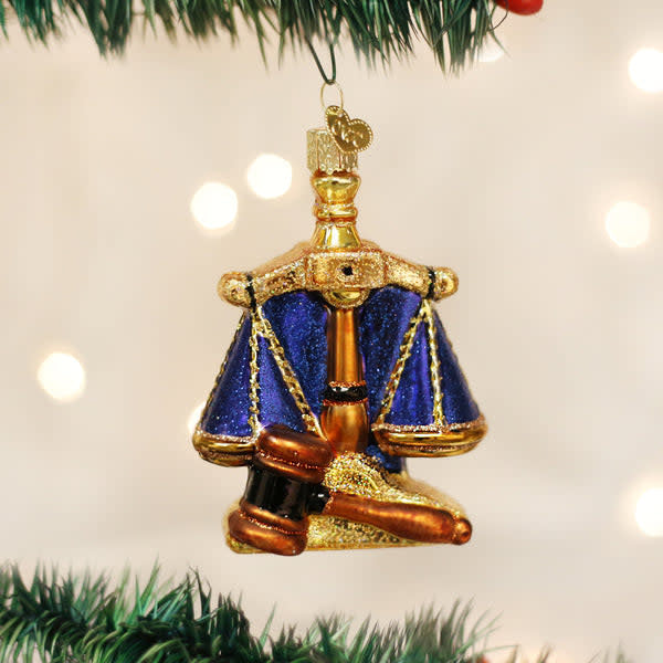 Metal Scales of Justice ornament with balanced pans on a central pillar.