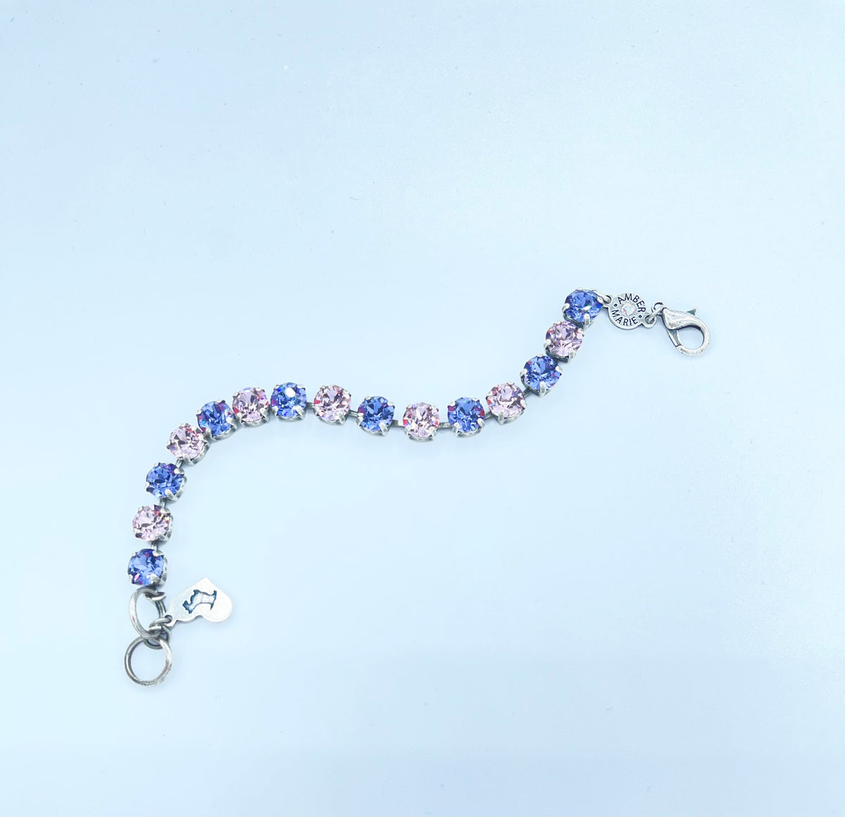 Classic Paris bracelet featuring lavender, lilac, white, and light green stones with an amber tag heart charm.