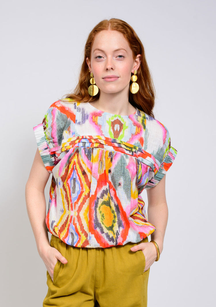 Geneva Elastic Waist Popover Top with vibrant abstract print, flutter sleeves, and pleated yoke.