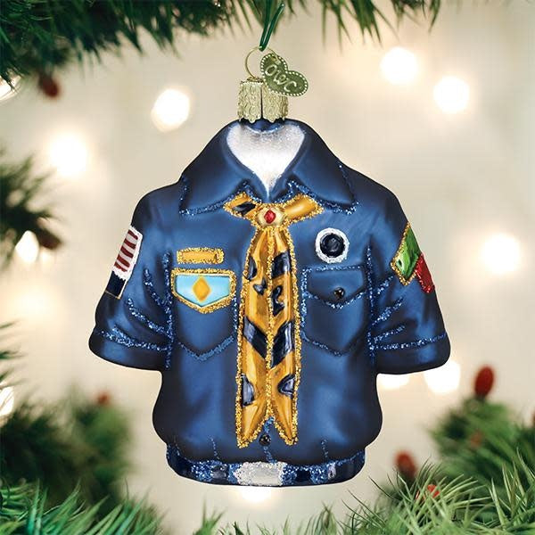 Hand-painted glass ornament featuring a scout uniform with badges in silver and glitter finish