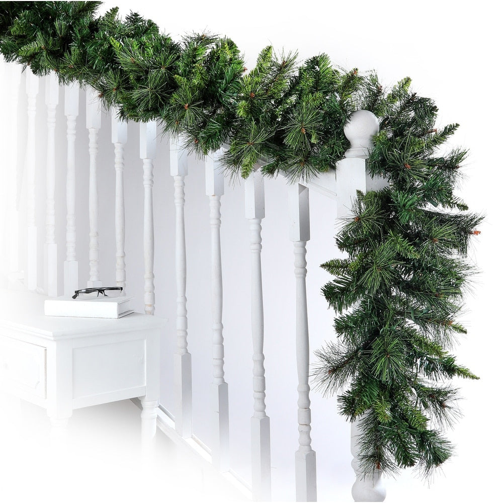 Belgium Garland with thick green pine needles draped over a white staircase banister.