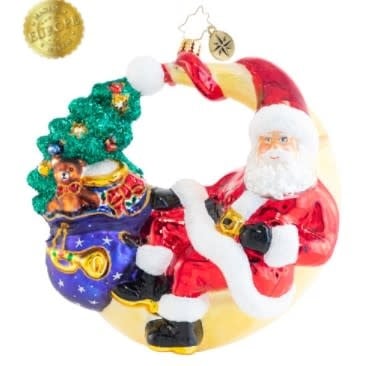 Festive crescent moon figurine with a Santa Claus face lounging on the curve.