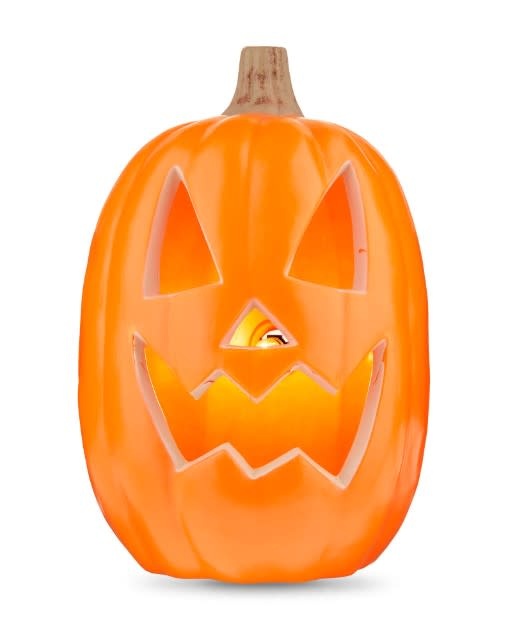 Black plastic pumpkin with glowing orange LED lights inside.