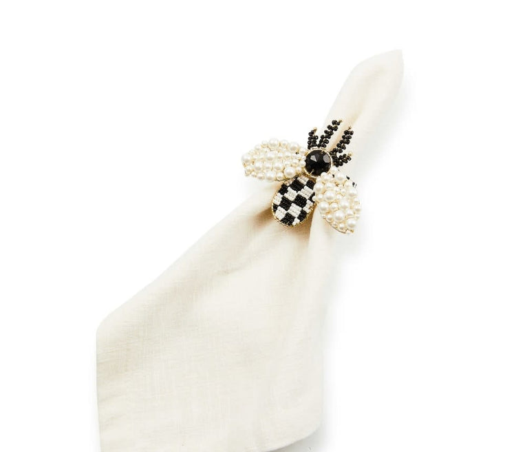 Bee napkin ring with black and white beads on an iron and brass frame.