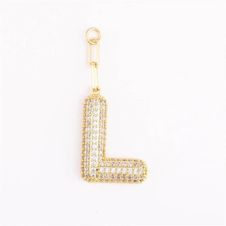 Heather-colored charm bag with gold plating, pave crystal accents, initial letter detail, and one-inch extender.