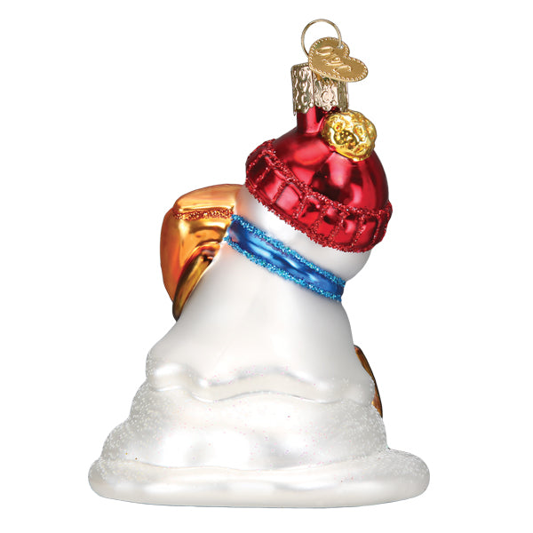 Back view of a glass snowman ornament wearing a red glittery hat and blue scarf.
