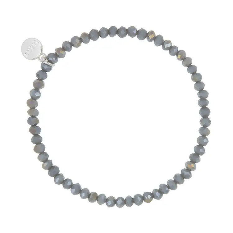 Lizas Quadro grey faceted crystal bead stretch bracelet with a silver logo charm.