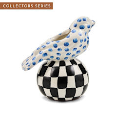 Mackenzie Childs Bird Vase with blue dots on a black and white checkered spherical base.