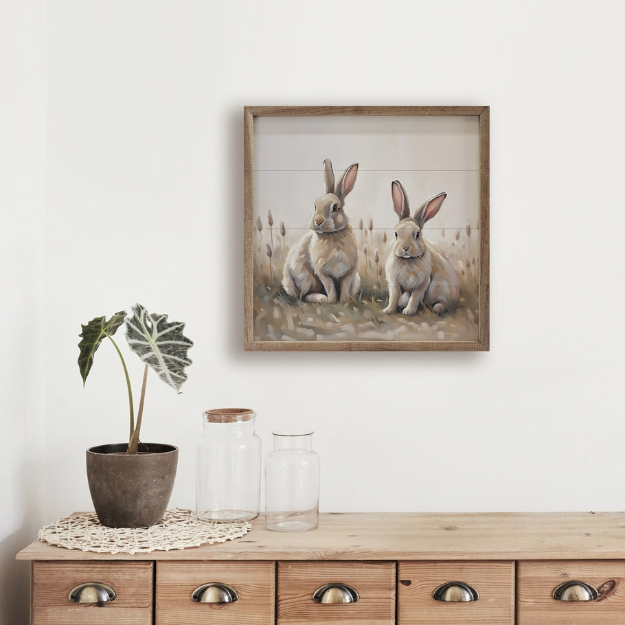Hand-painted wooden wall art featuring two neutral-colored rabbits in a natural walnut frame.