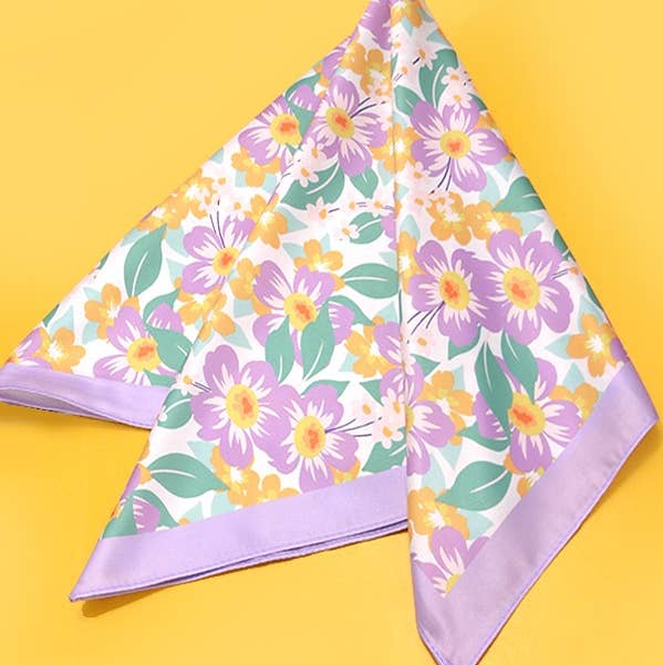 Silky tropical flower print bandana scarf with a flowing rectangular shape.