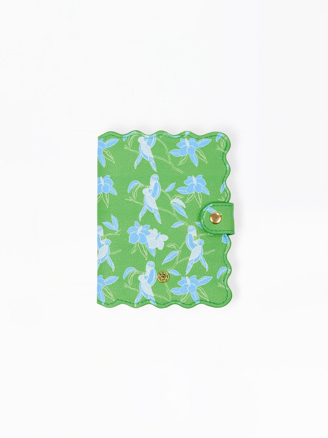 Green vegan leather passport cover with a blue tropical bird and flower print and scalloped edges.