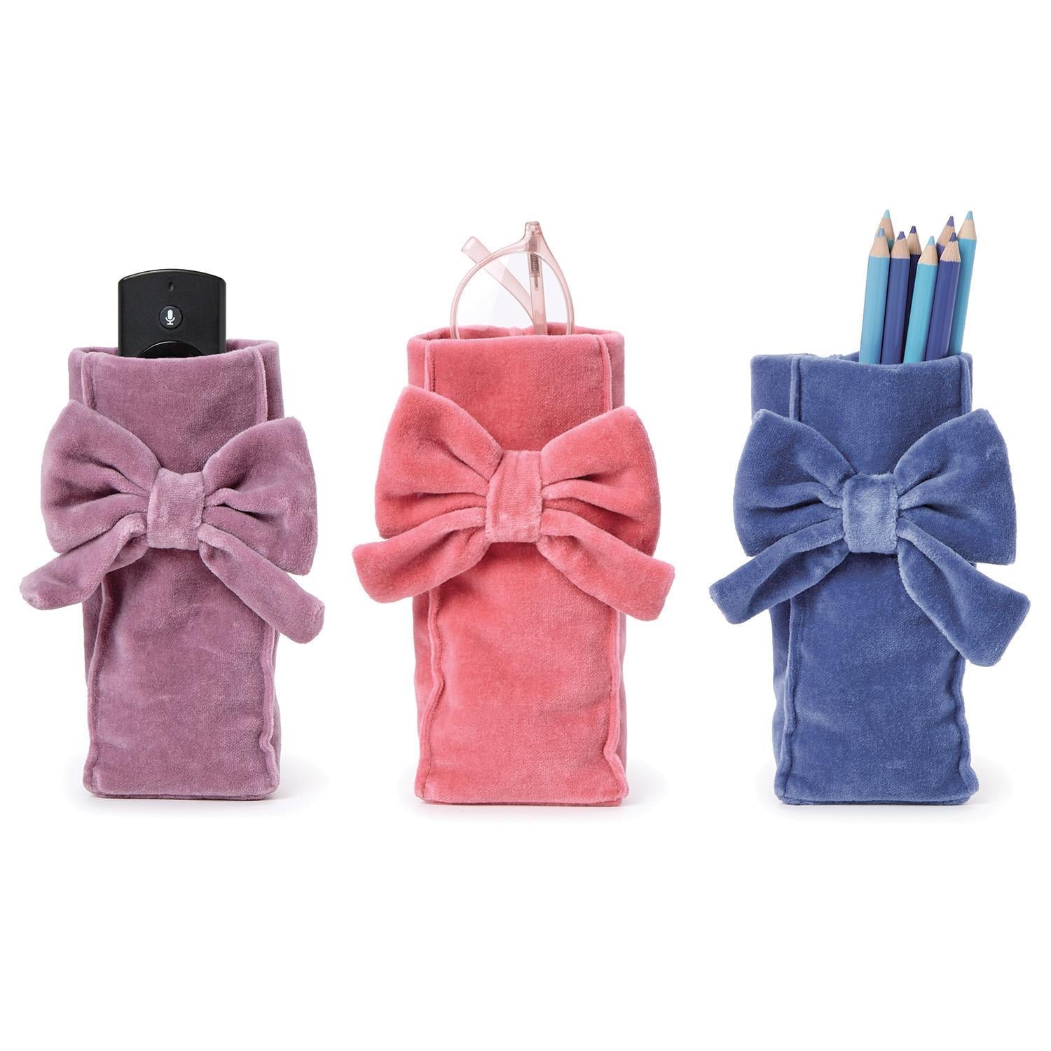 Handcrafted soft cotton velvet bow eyeglass holder in pink with a weighted base and velvet accent.