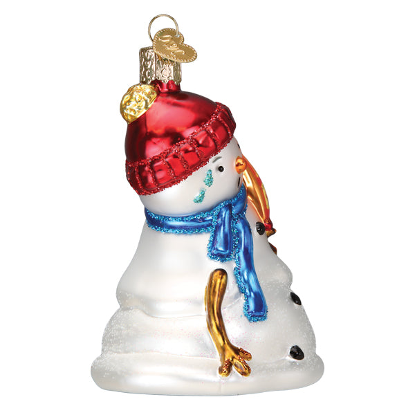 Glass snowman ornament wearing a red hat and blue scarf, holding a bag of Flamin' Hot Cheetos.