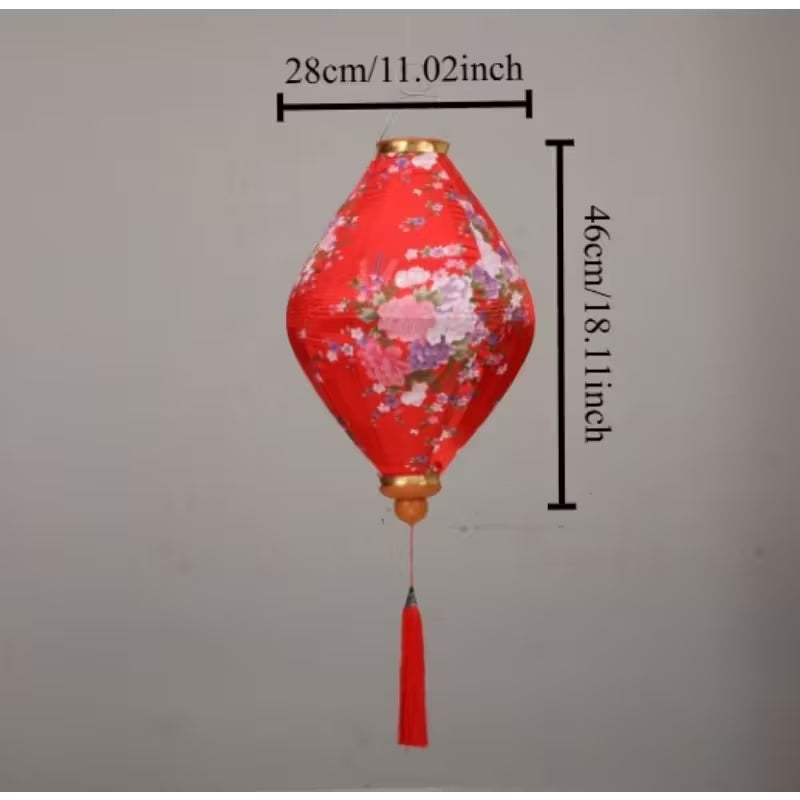 Traditional Chinese silk lantern with red fabric, gold accents, circular frame, and intricate cutout patterns.