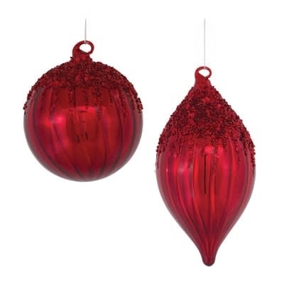 Round glass ornament with gold sequin embellishments on a clear background