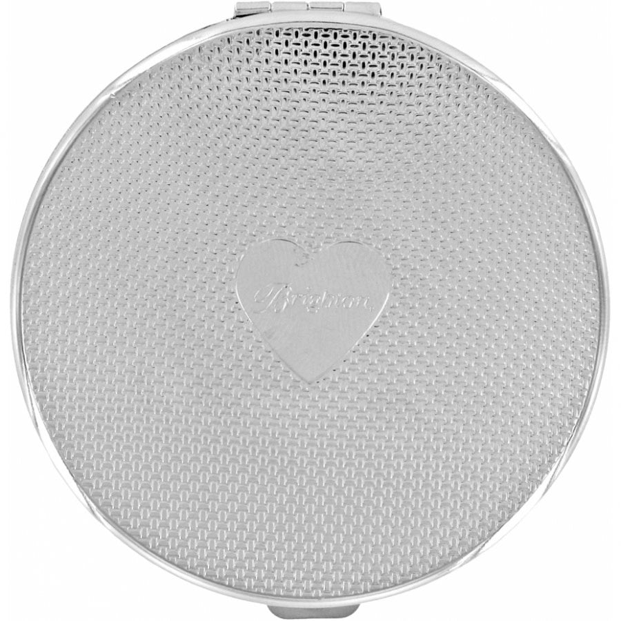 Silver plated compact mirror with sculpted frieze patterns on the back.