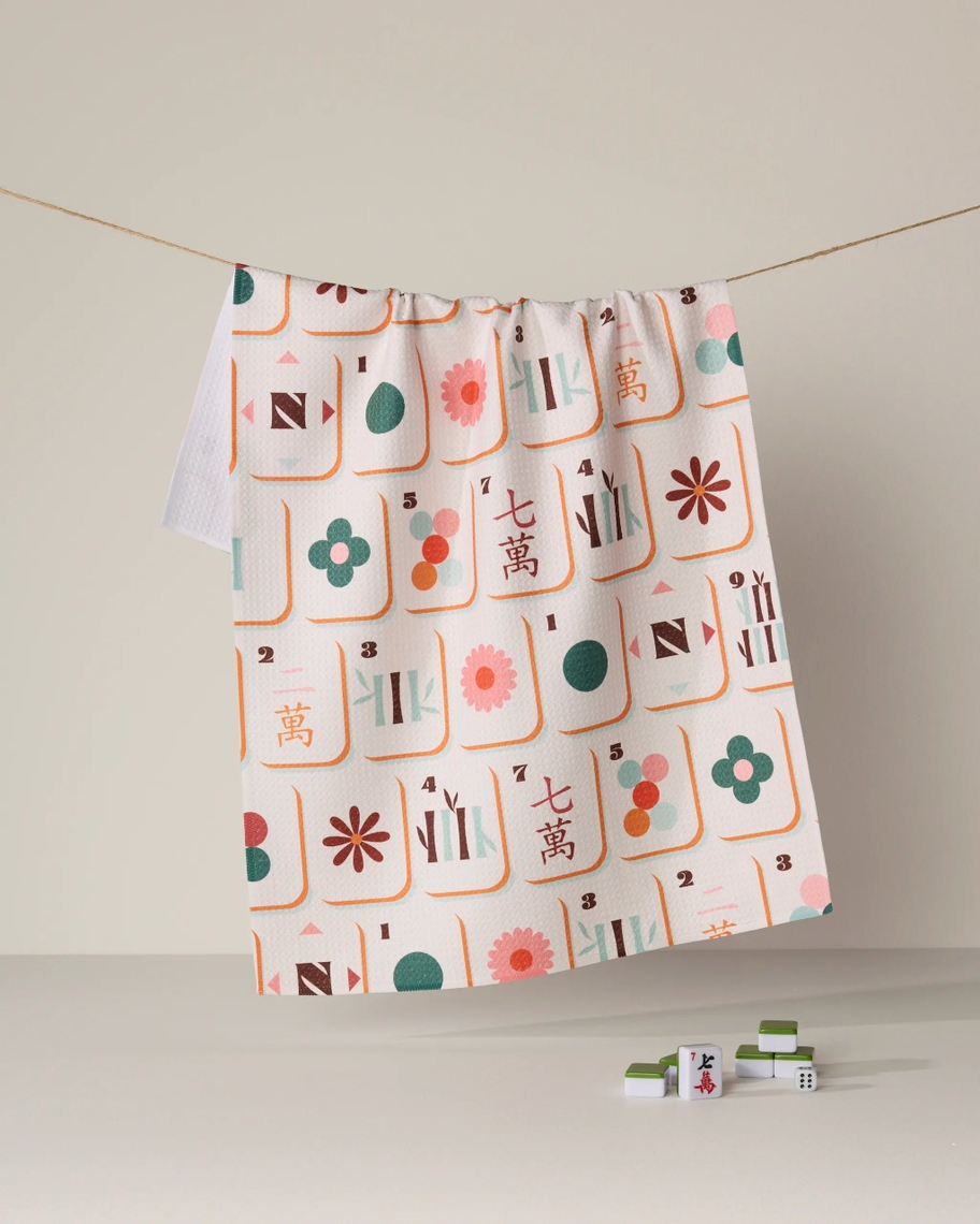 Everyday Tea Towel with a colorful mahjong tile pattern hanging on a string line.