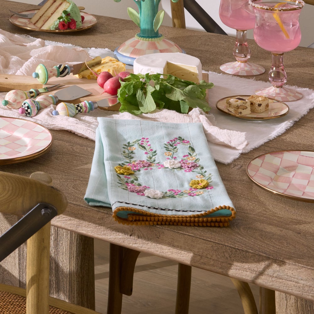 Light blue Floral Bunny Embroidered Dish Towel on a wooden table with spring-themed table decor.