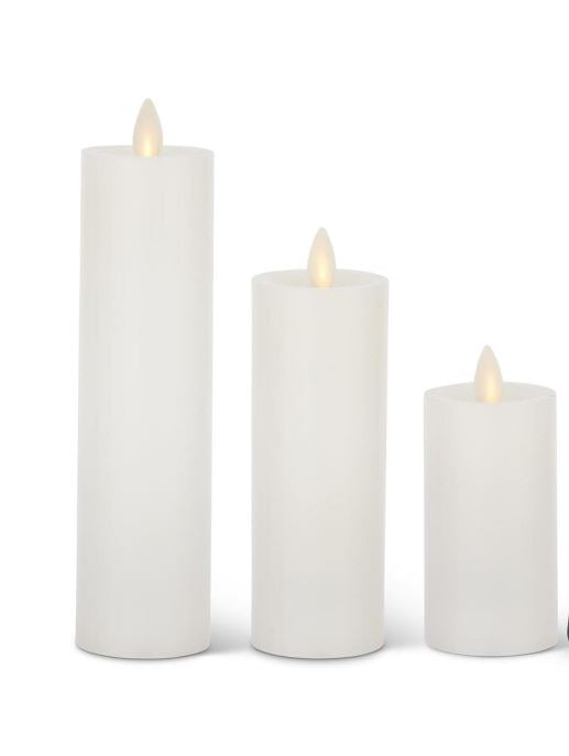 Three white wax Luminara slim indoor pillar candles in varying heights with glowing LED flames.