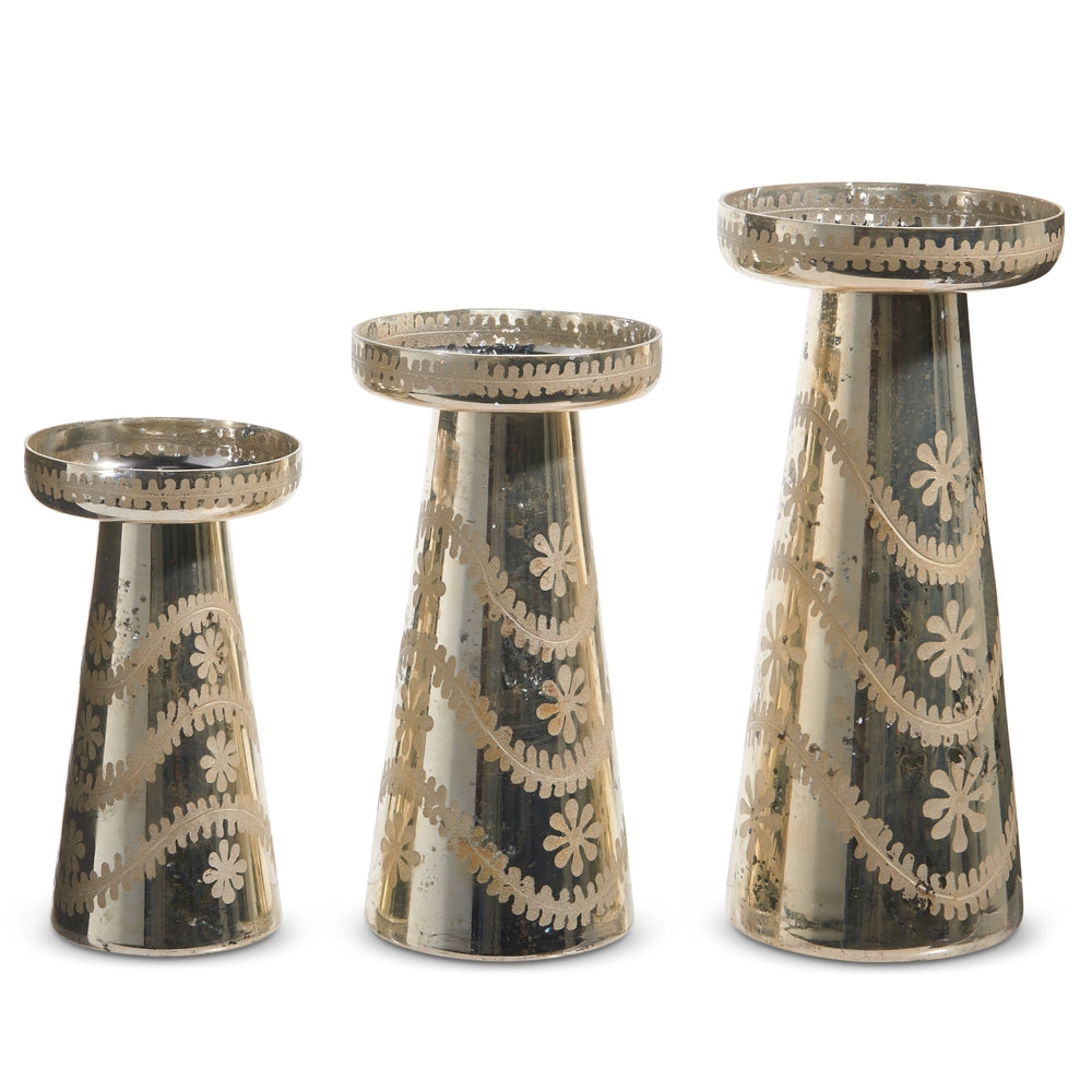 Set of three etched silver mercury glass candle holders in varying heights with reflective finish.