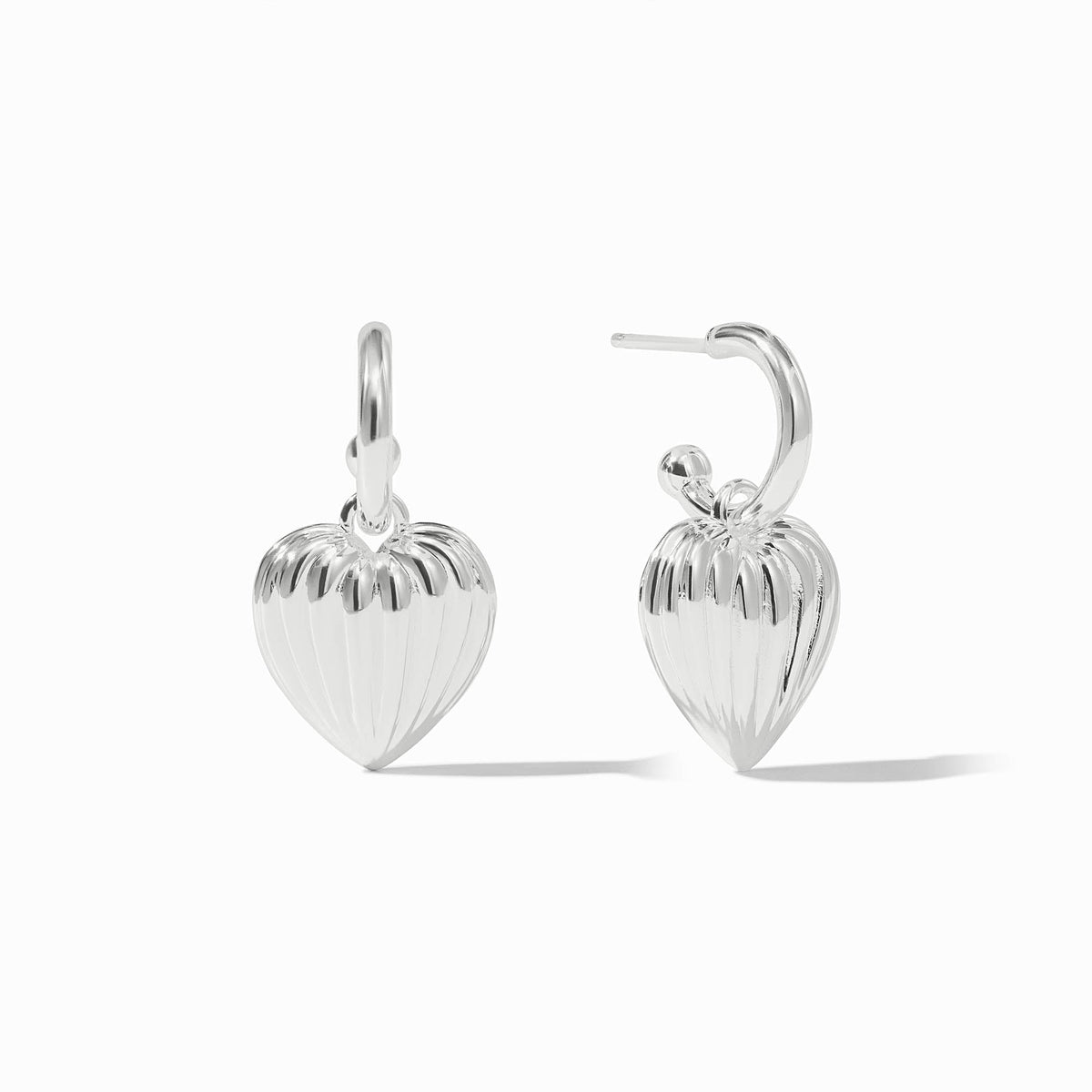 Silver puffy heart hoop and charm earrings with a ribbed texture on the heart charms.