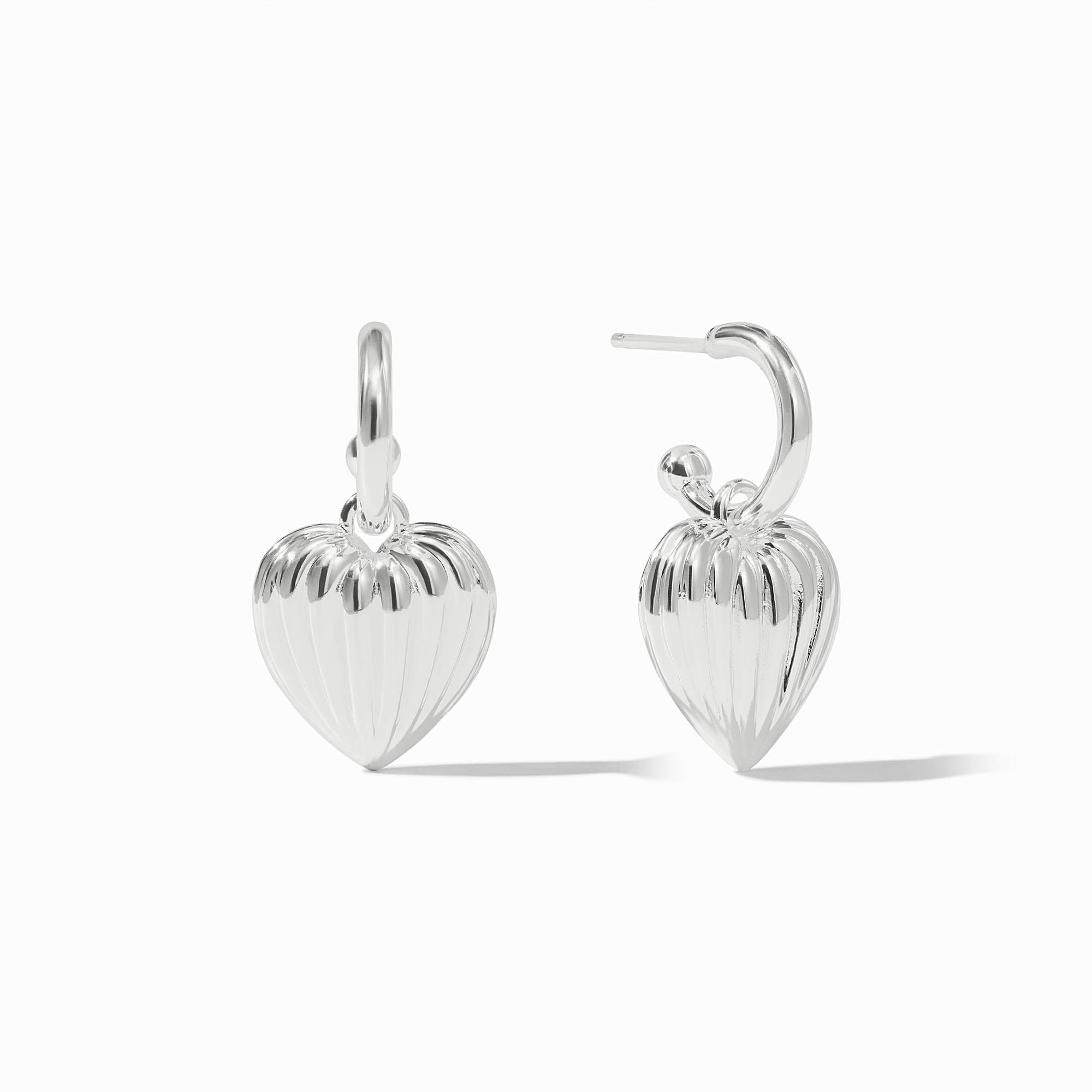 Silver puffy heart hoop and charm earrings with a ribbed texture on the heart charms.