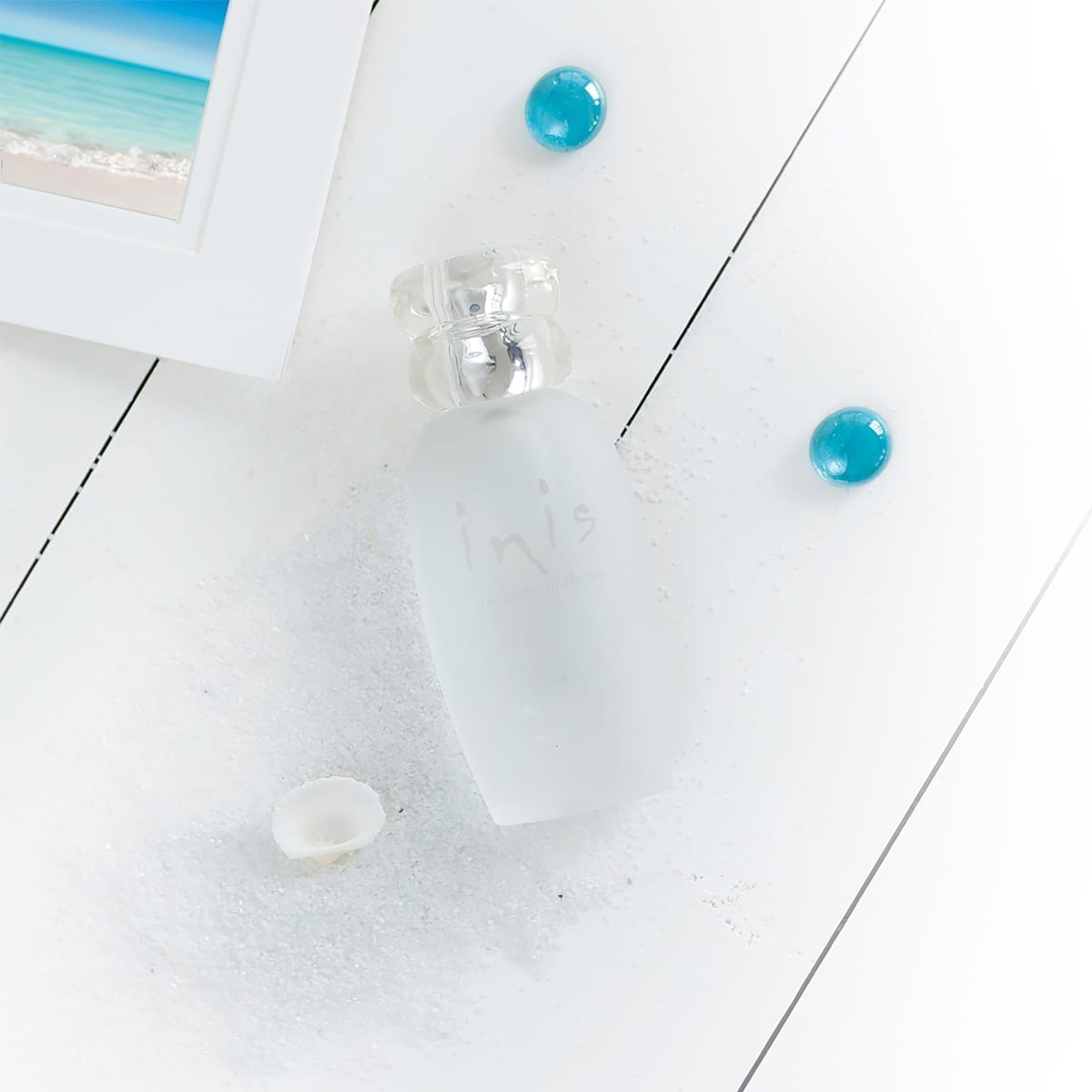 Frosted glass bottle of Inis Cologne Spray with pebble-style cap