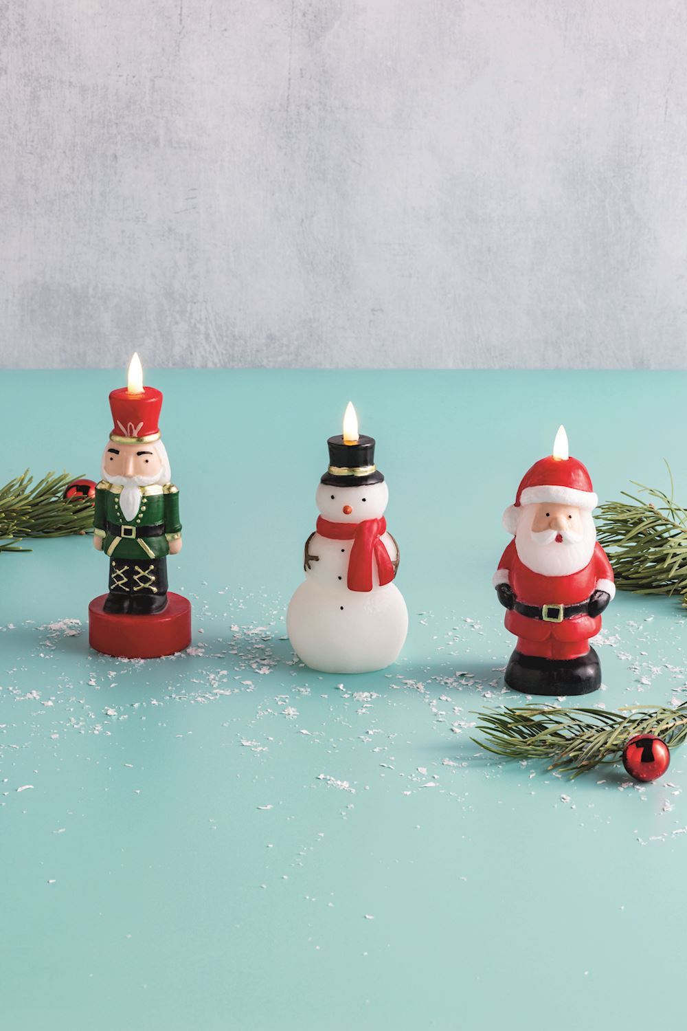Black figural candle holder shaped like a Christmas tree with flameless LED lights