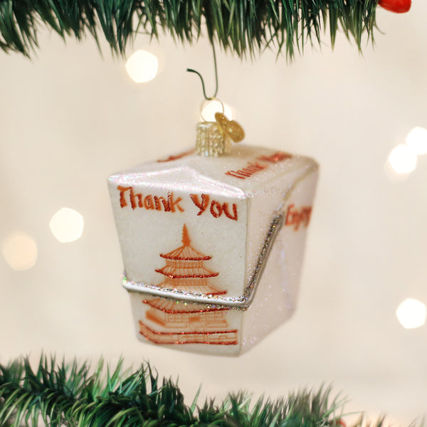 Glass Chinese take-out box ornament with 'Thank You' text and pagoda design on a Christmas tree.