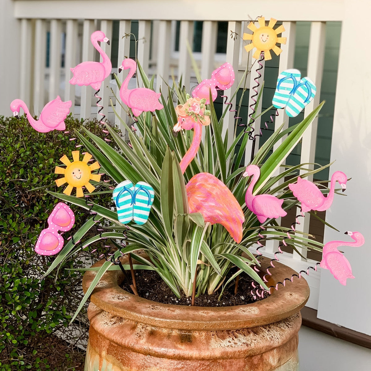 Flamingo Trio Stake: a decorative garden stake featuring three pink flamingos in silhouette against a neutral background.