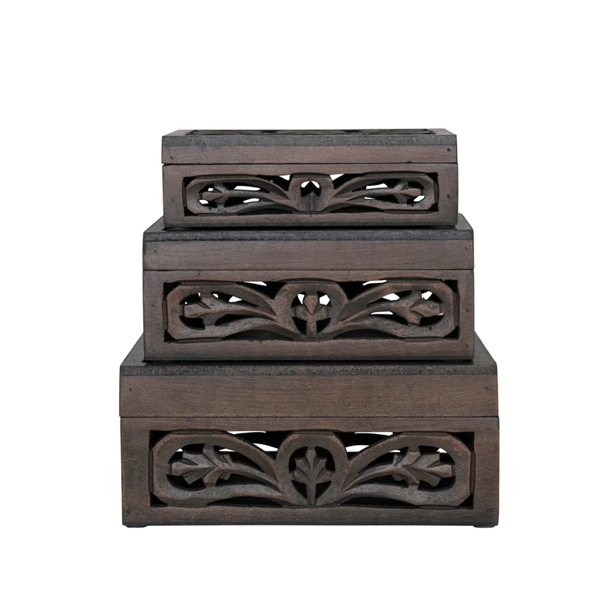Set of three nesting boxes with carved MDF sides and mango wood tops in natural tones.