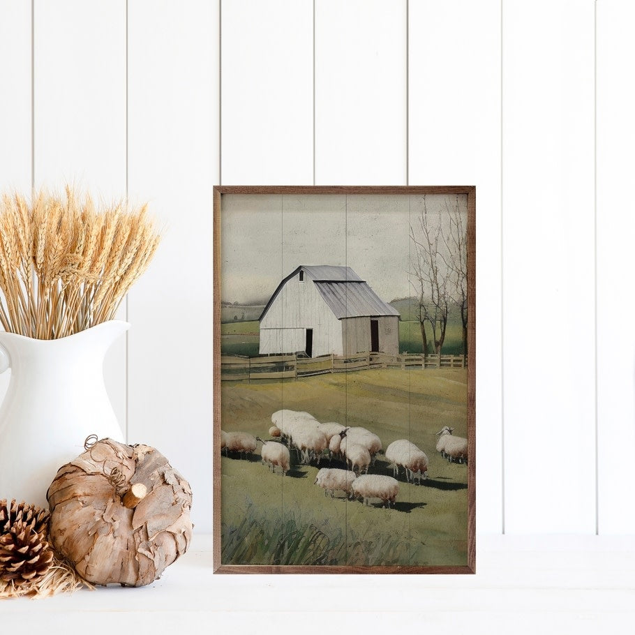 Hand-painted wooden wall art featuring a sheep in front of a barn silhouette with natural walnut frame.