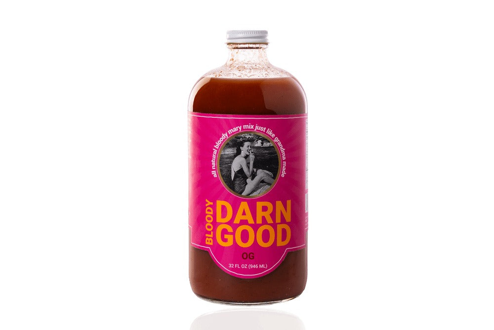 32 oz bottle of OG Bloody Darn Good Bloody Mary Mix with a pink label and white cap.
