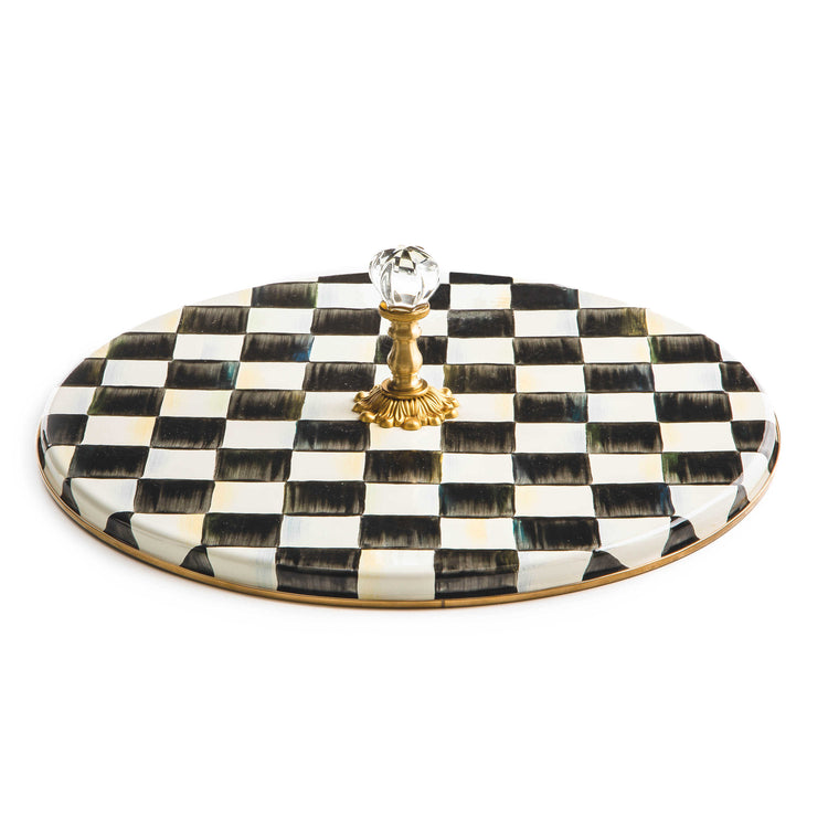Round Courtly Check enamel cheese platter with a hand-painted black and white pattern and brass knob.