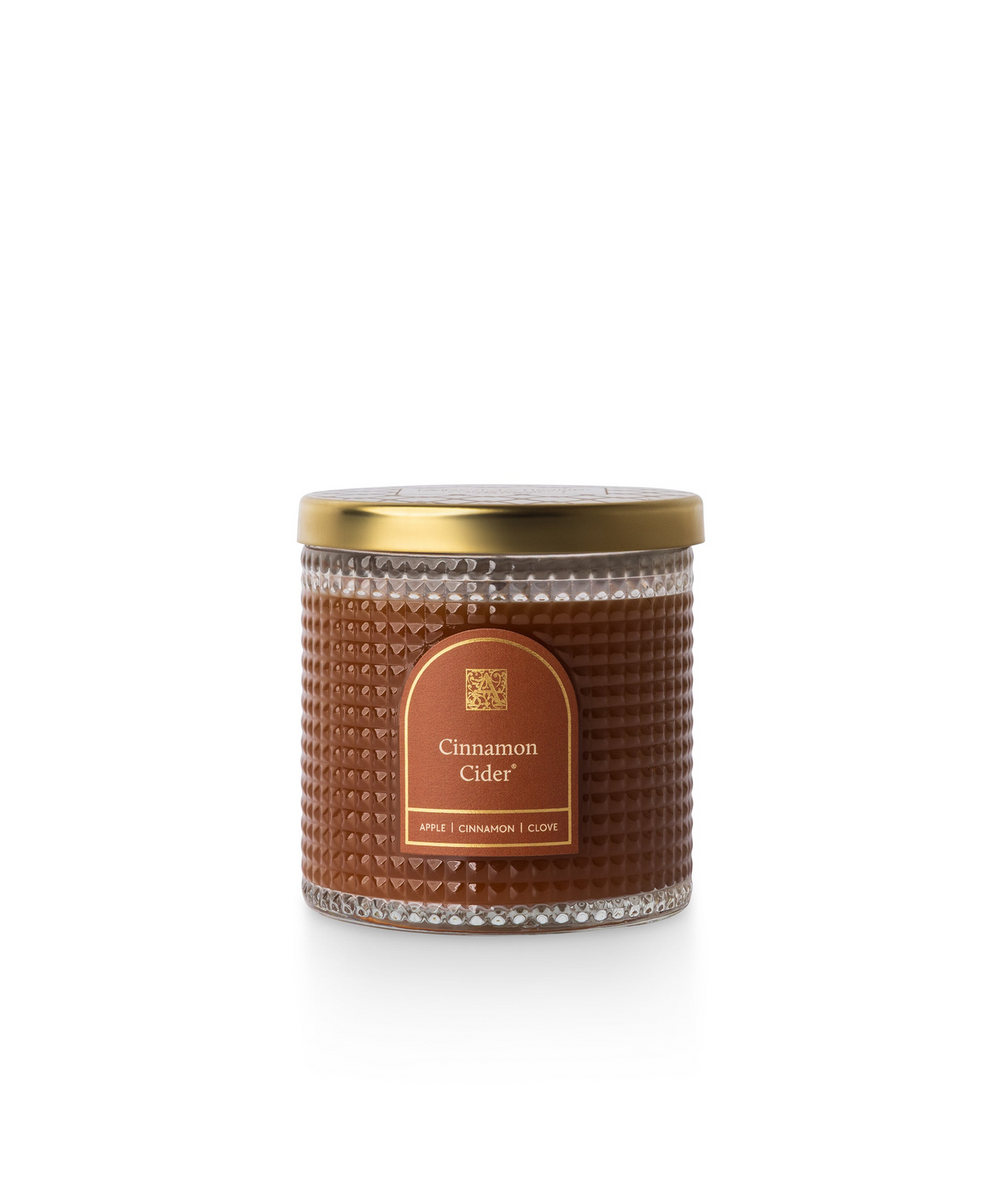 Cinnamon Cider scented candle in a textured glass jar with a gold lid and brown label.
