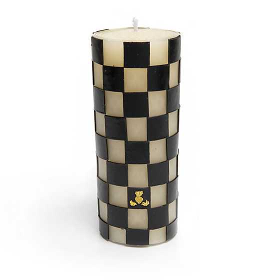 6 inch black and white checkered pillar candle with a small gold logo near the base.