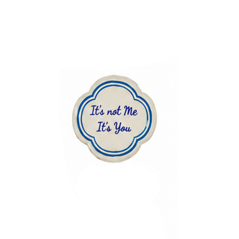 Hand-painted stoneware magnet with blue script reading "It's not Me It's You" in a quatrefoil shape.
