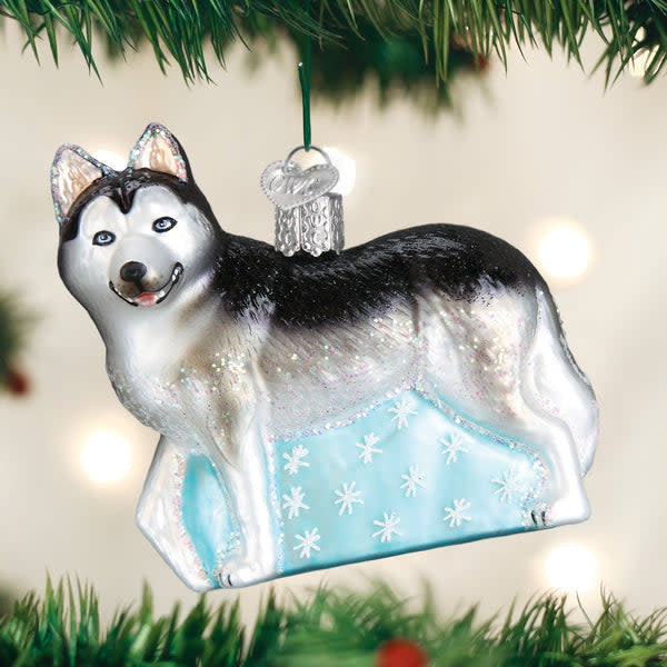 Siberian Husky ornament figurine in white fur with black markings on a silver stand.