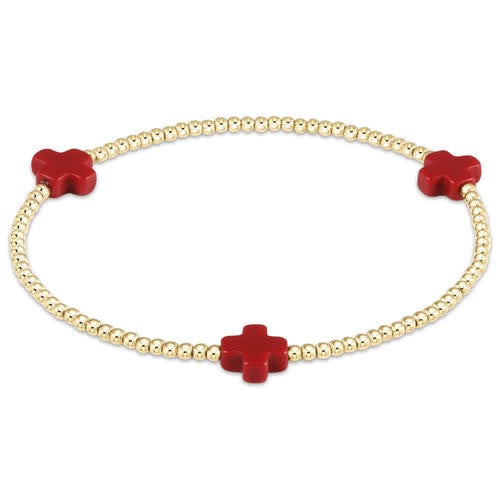 Red elastic bracelet with a signature cross gold pattern made from 2mm beads.