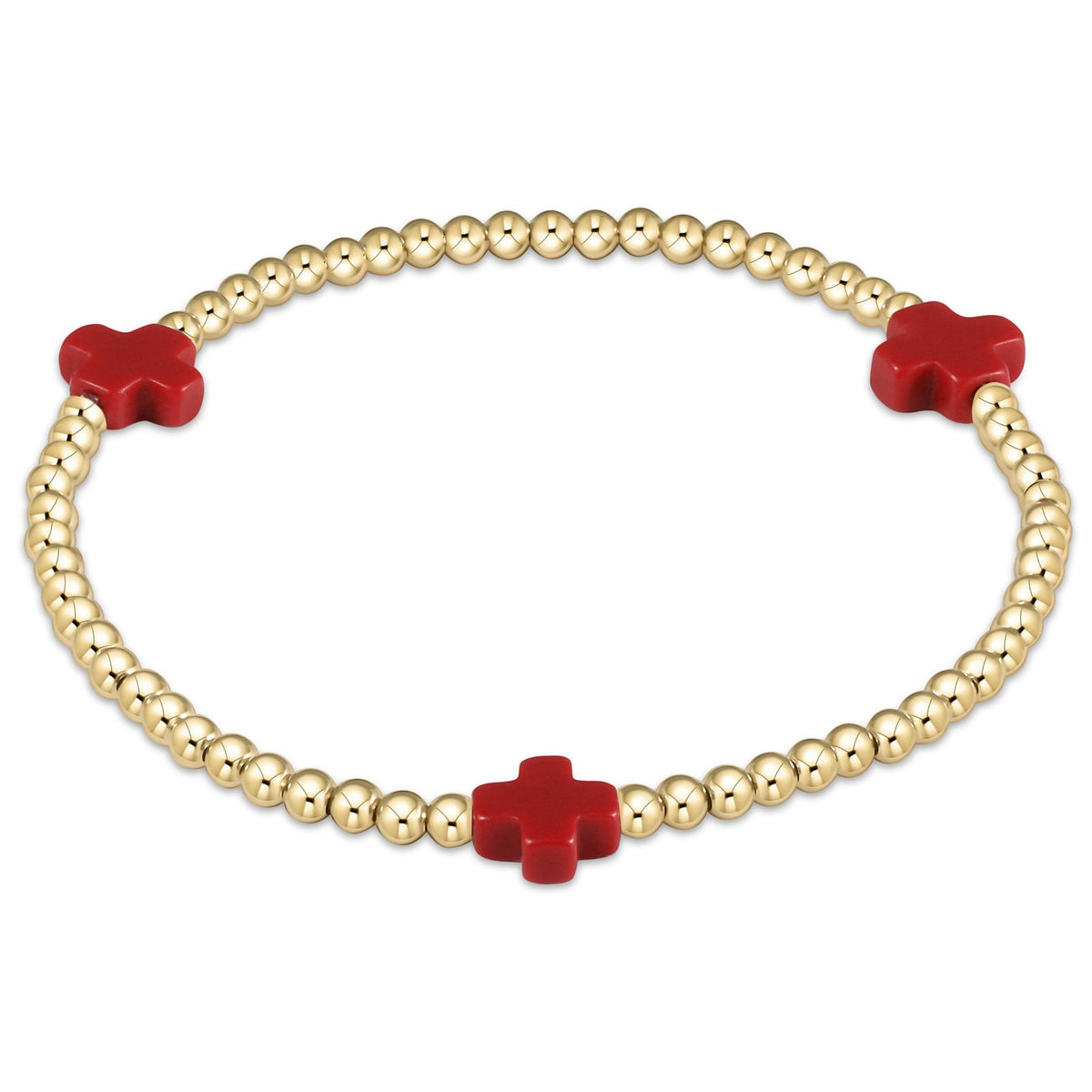 Red elastic bracelet featuring a signature gold cross pendant with three millimeter gold-filled beads.
