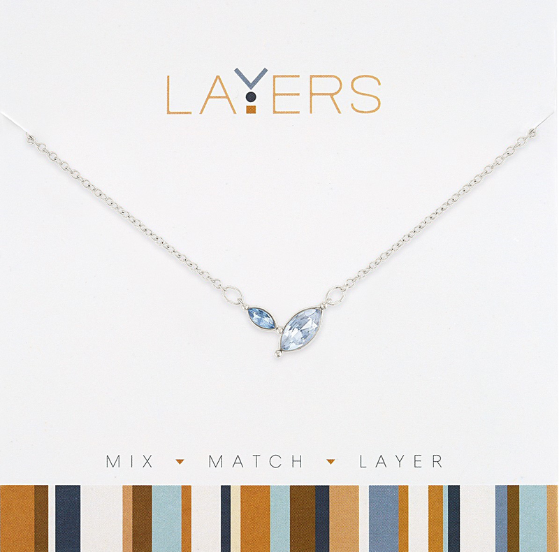 Silver necklace with two marquis-cut sapphire stones on a layered chain.