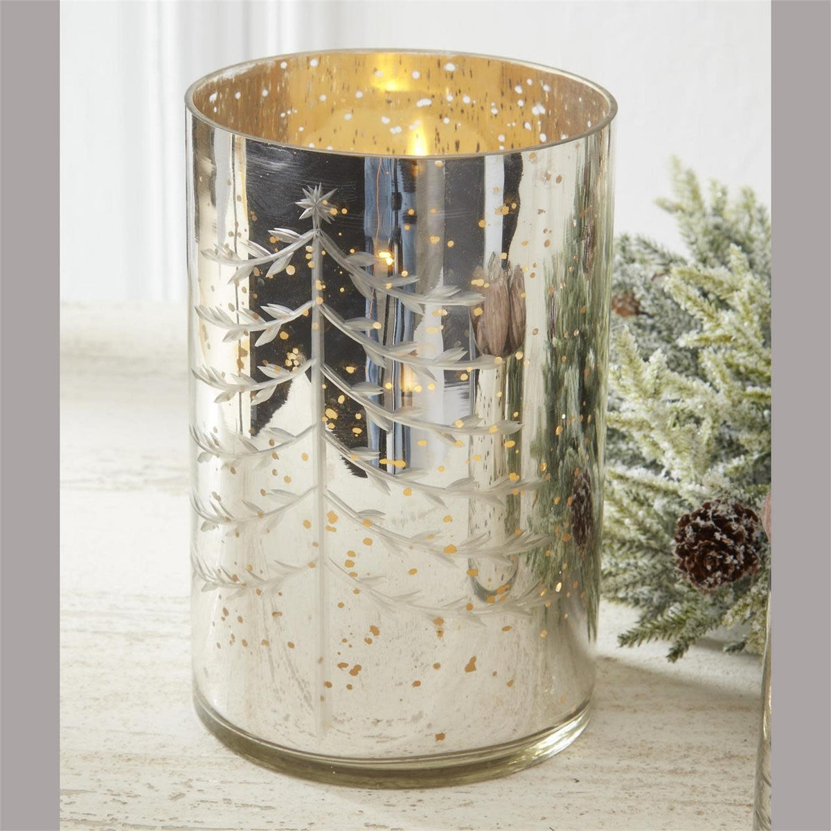 Silver mercury glass candleholder with a festive Christmas tree silhouette