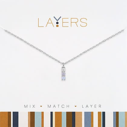Silver petite blue trio layers necklace featuring three delicate chains with small blue gemstone accents.