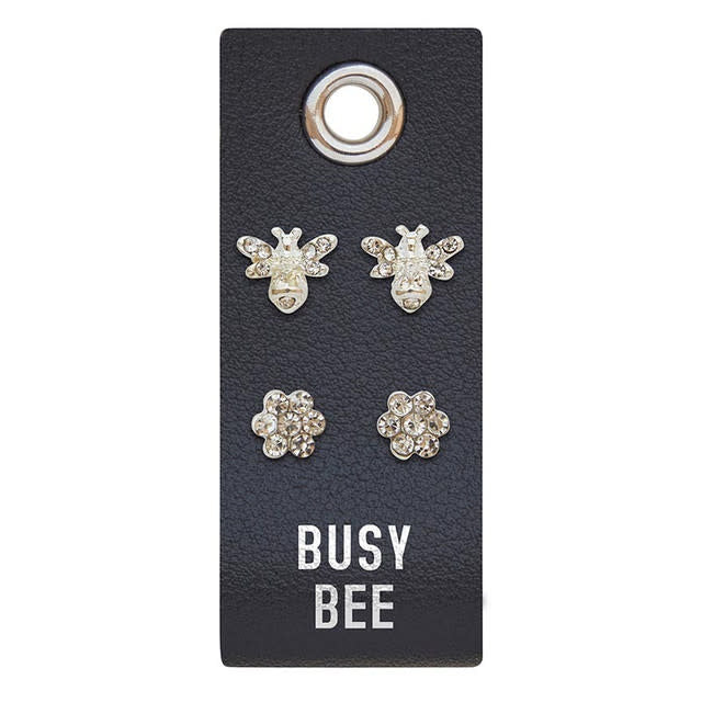 Silver stud earrings featuring a PU leather tag with rhinestone accents.