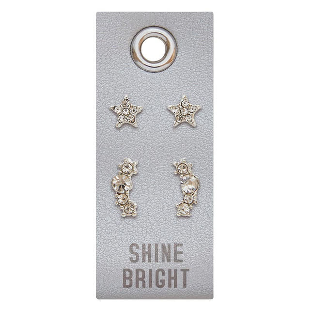 Silver stud earrings with rhinestone accents on a PU leather tag.